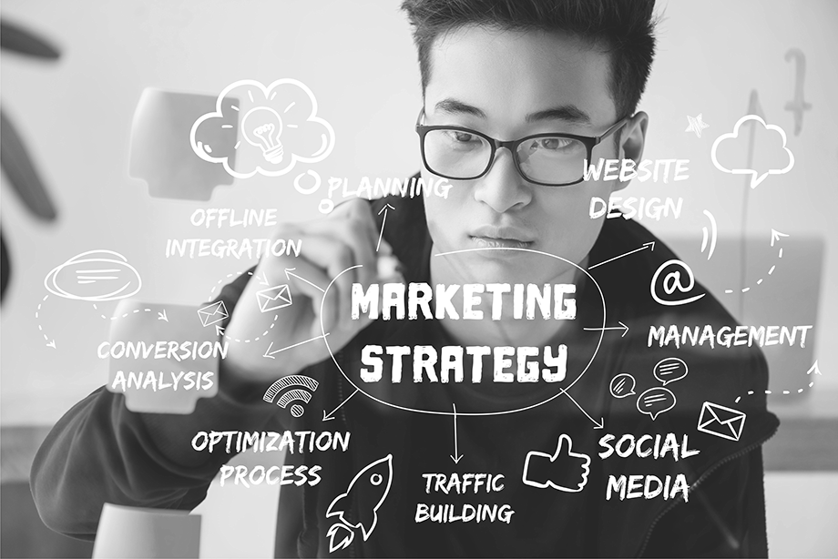 Man drawing a marketing strategy diagram, illustrating step-by-step marketing guidance.